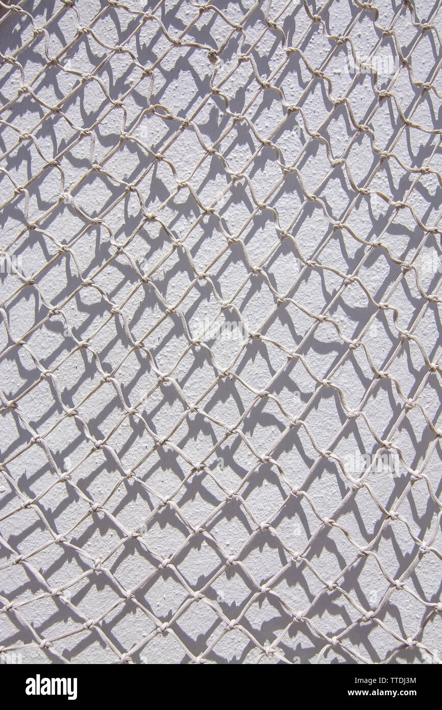 White fishing net against white wall background texture marine style Stock Photo