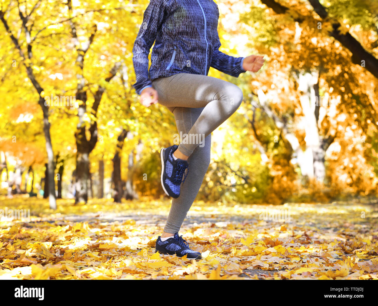 Young woman jogging in autumn park Stock Photo - Alamy