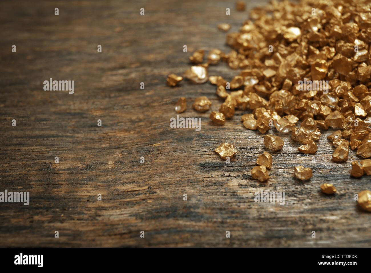 A pile of Gold nugget grains, on wooden background Stock Photo - Alamy