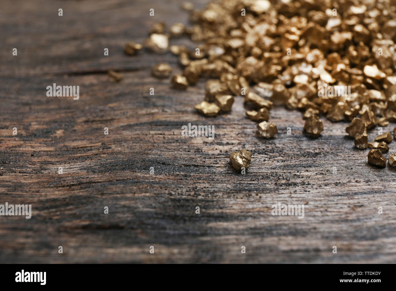 A pile of Gold nugget grains, on wooden background Stock Photo - Alamy