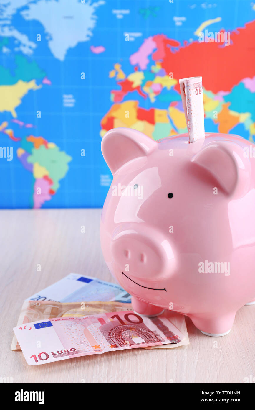 Money box pig on world map background Stock Photo - Alamy