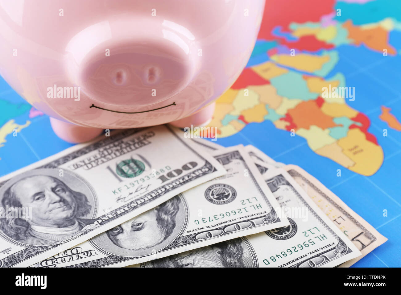 Money box pig on world map background Stock Photo - Alamy