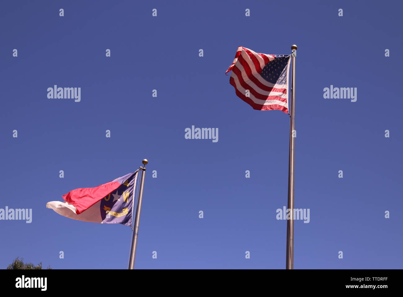 American Flag and North Carolina flag on a flag pole. Stock Photo