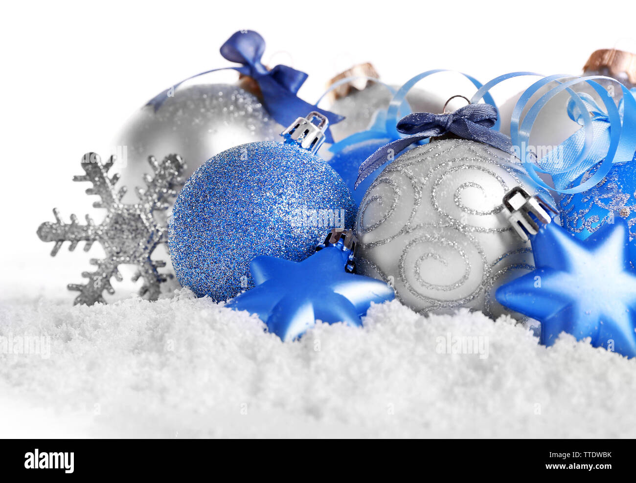 Christmas balls on snow with white background Stock Photo - Alamy