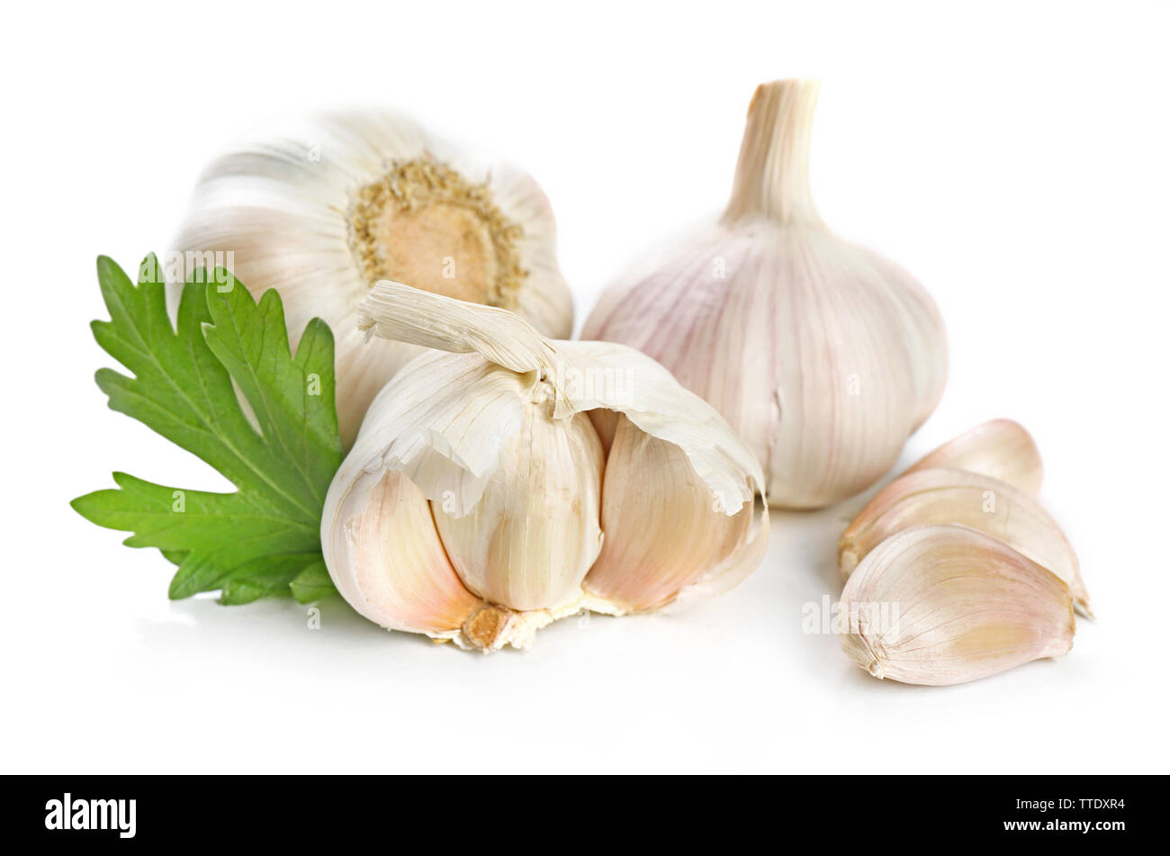 Garlic with leaves of parsley isolated on white Stock Photo - Alamy