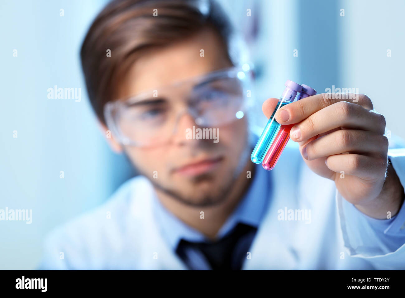 Man in laboratory checking test tubes Stock Photo Alamy