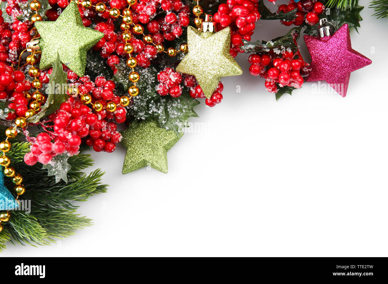 Christmas tree branch with red berries and decorations on white ...