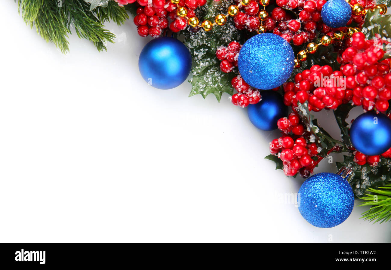 Christmas tree branch with red berries and decorations on white ...