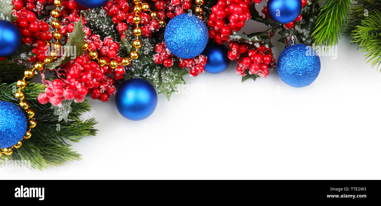 Christmas tree branch with red berries and decorations on white ...