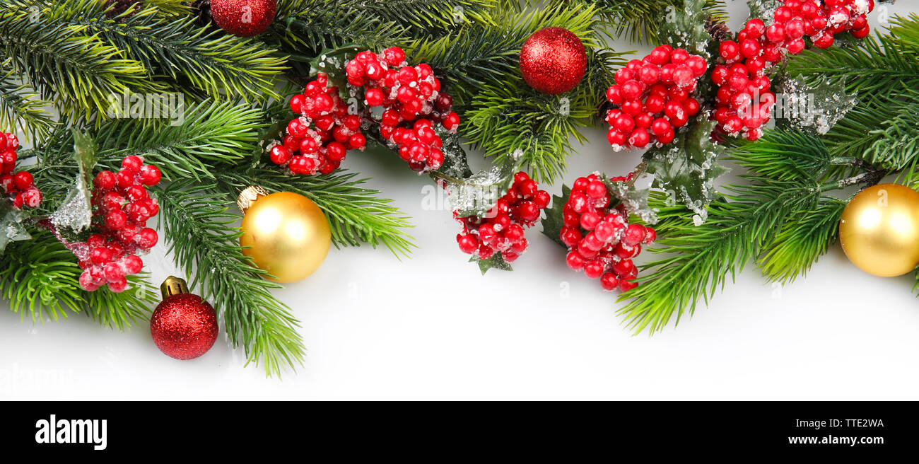 Christmas tree branch with red berries and decorations on white ...