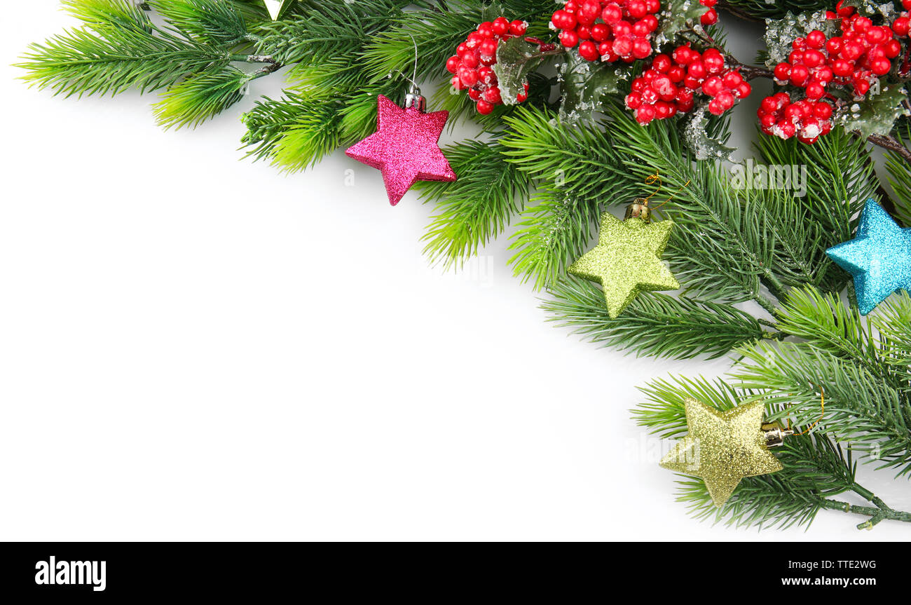 Christmas tree branch with red berries and decorations on white ...