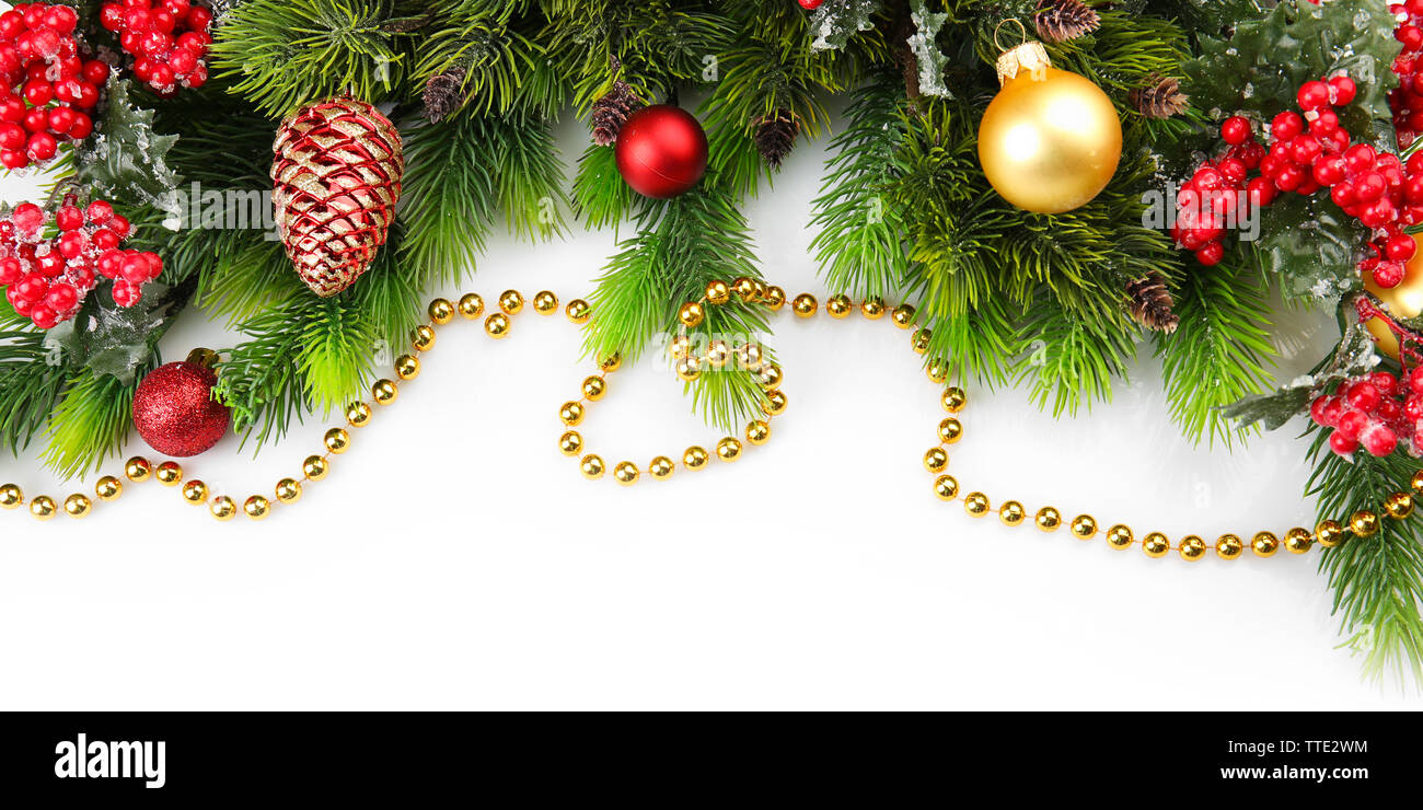 Christmas tree branch with red berries and decorations on white ...
