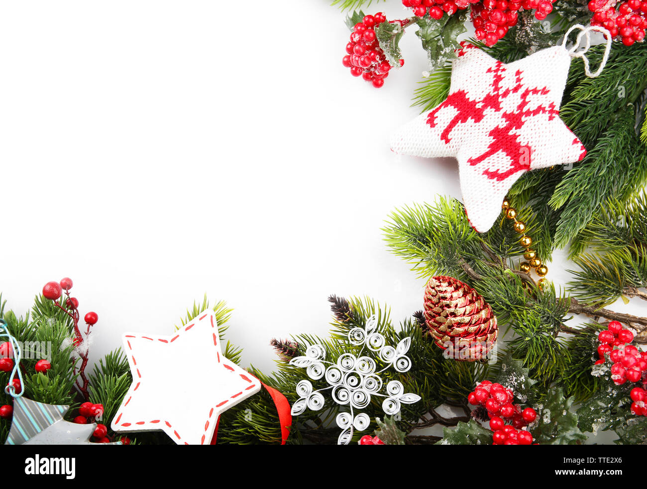 Christmas tree branch with red berries and decorations on white ...