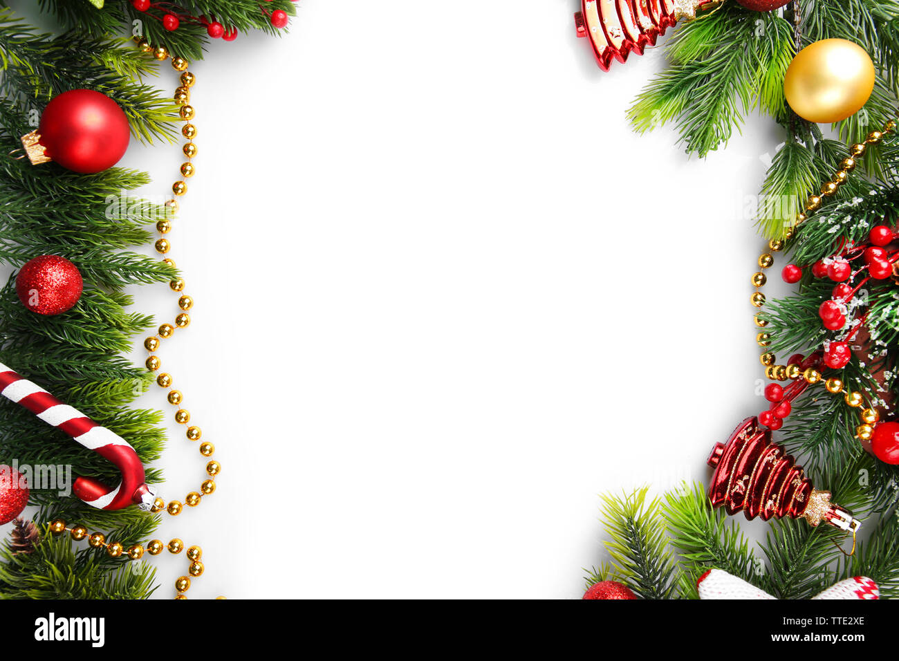 Christmas tree branch with red berries and decorations on white ...