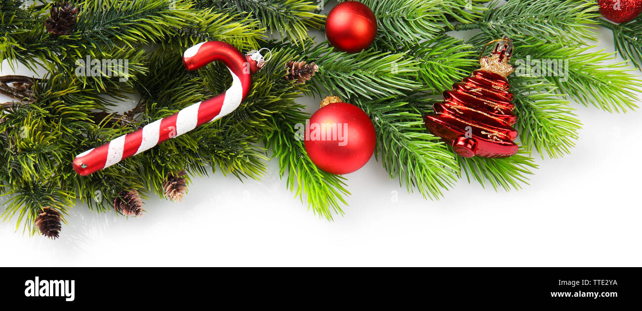 Christmas tree branch with red berries and decorations on white ...