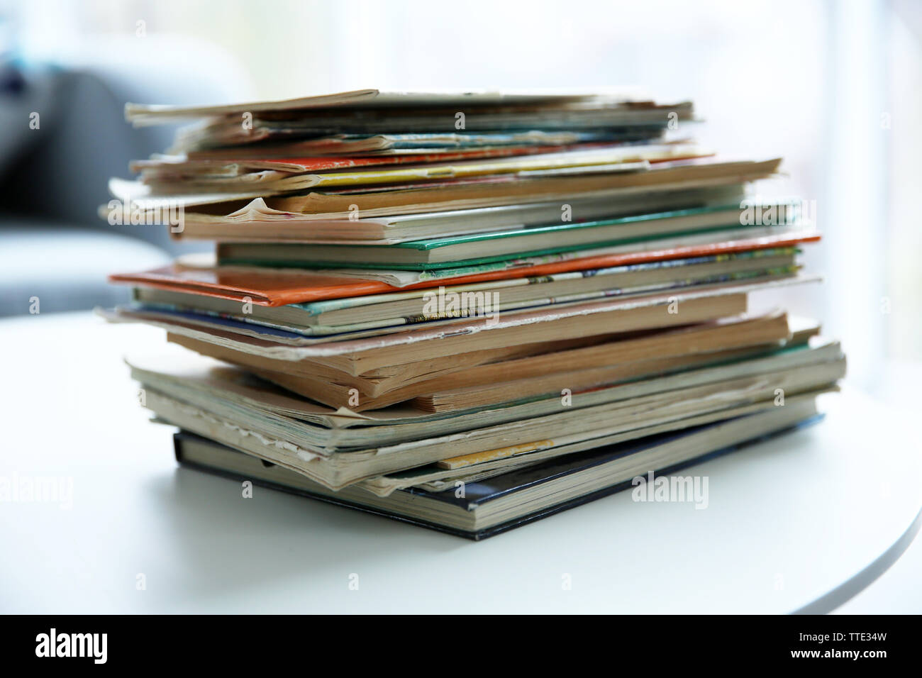 Pile of old books on white table Stock Photo - Alamy