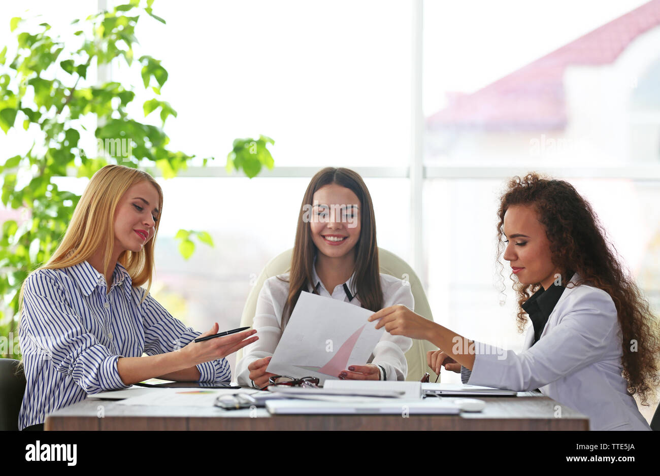 Three young businesswomen at the meeting in a conference room Stock ...