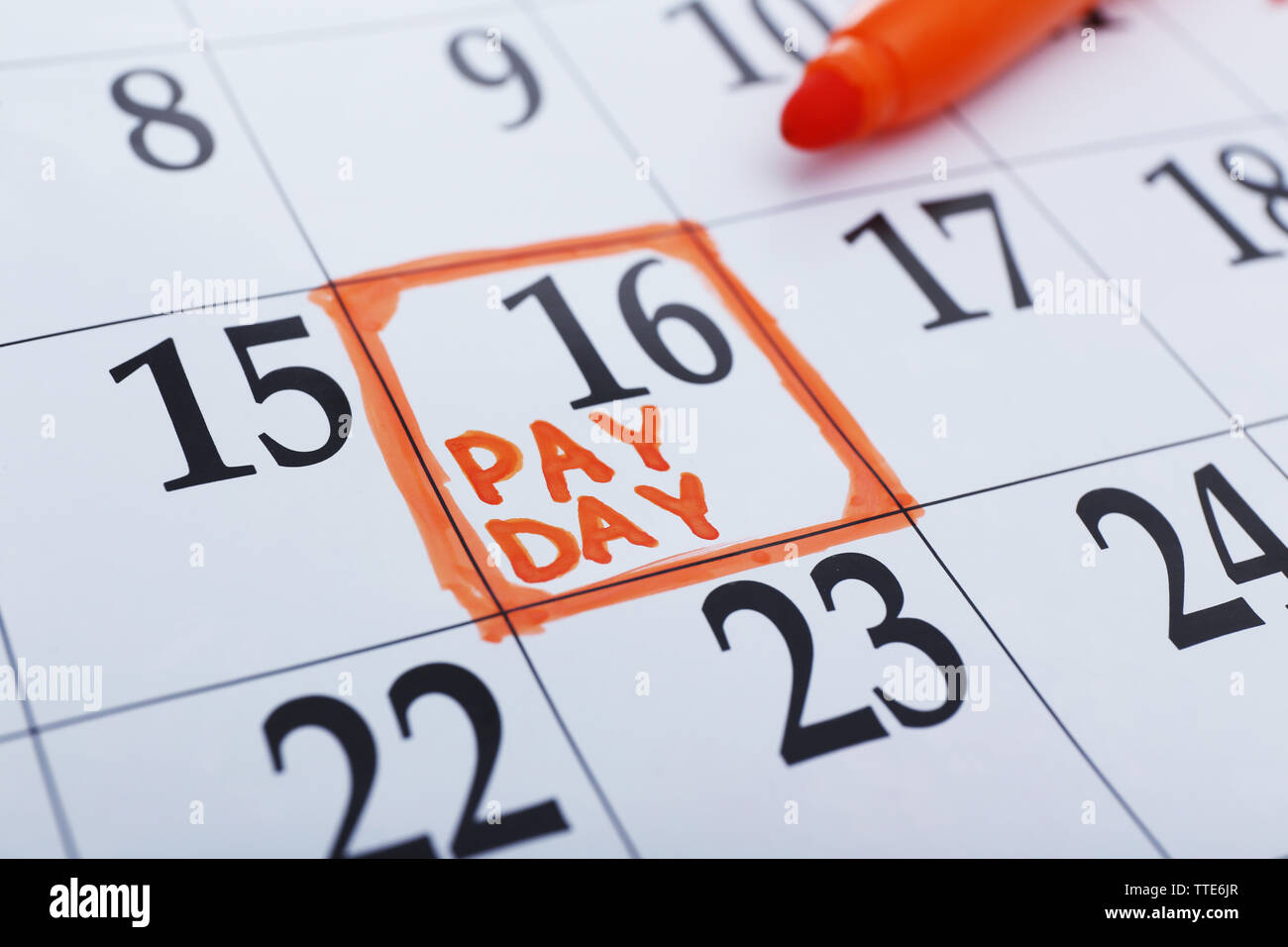 Payday concept. Calendar with orange felt pen background. Date in frame