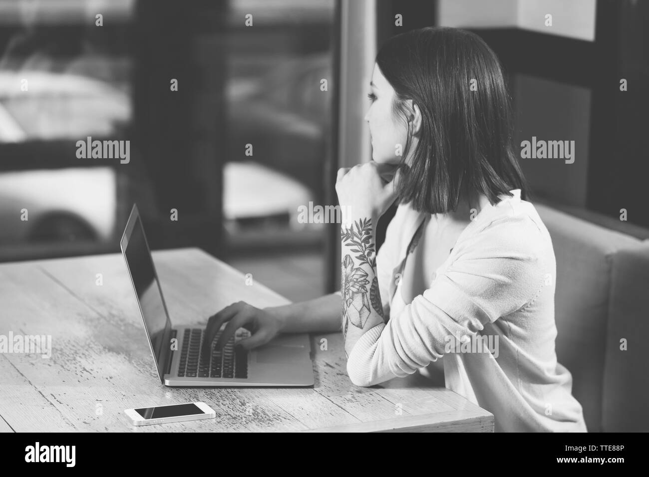 Young woman with laptop in cafe Stock Photo - Alamy