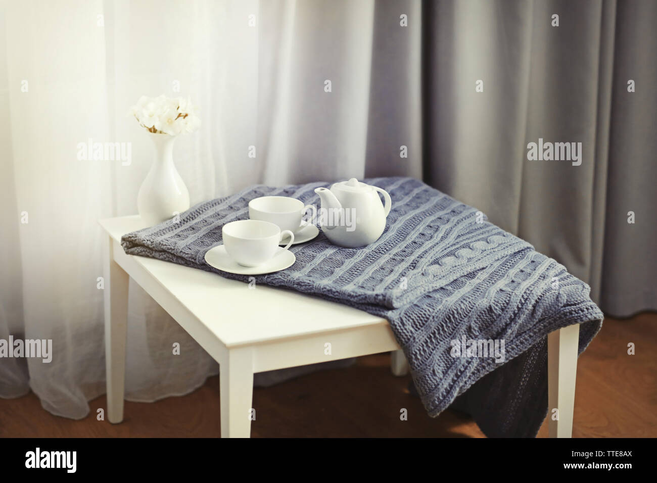 Little table in the room in front of window with curtains Stock Photo ...