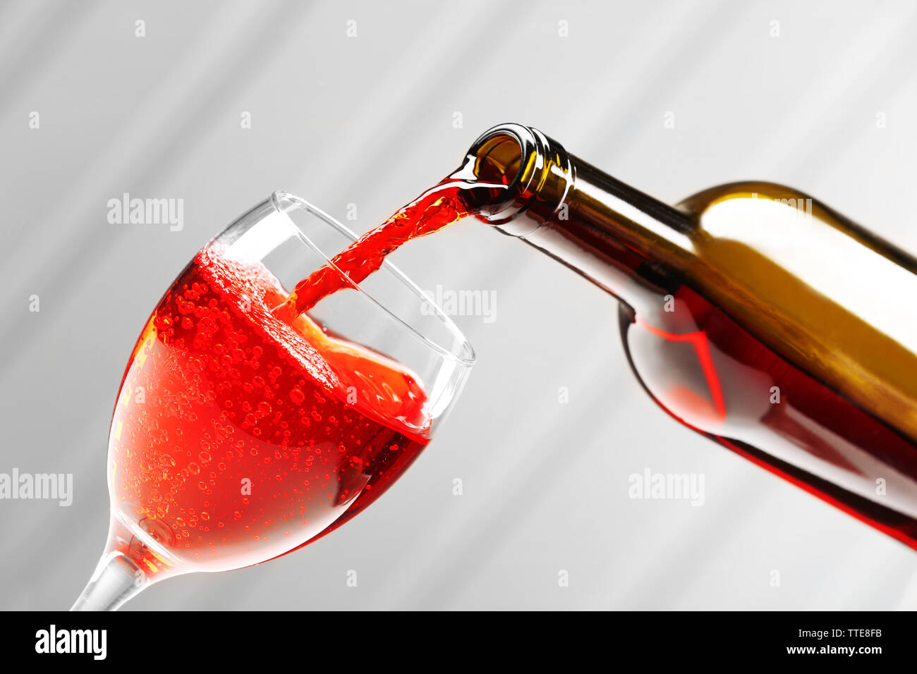 Pouring wine on wall background Stock Photo - Alamy