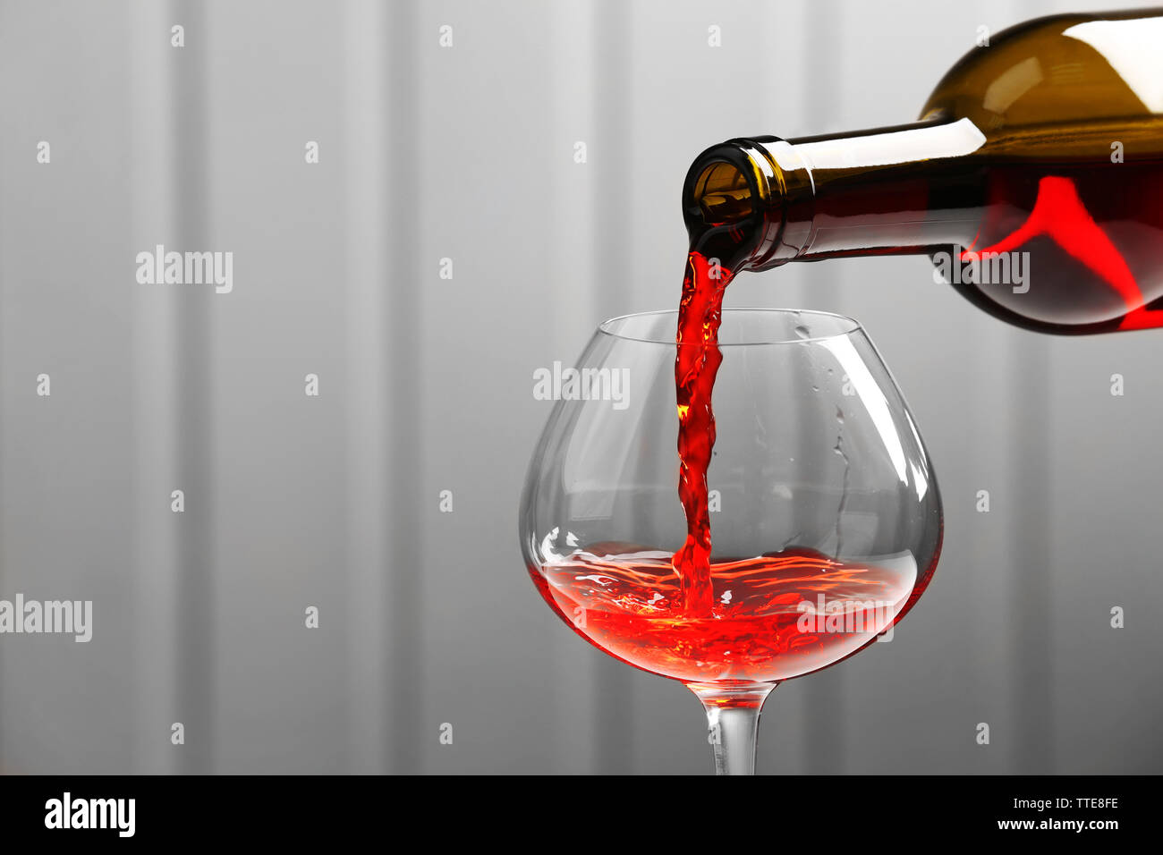 Pouring wine on wall background Stock Photo - Alamy