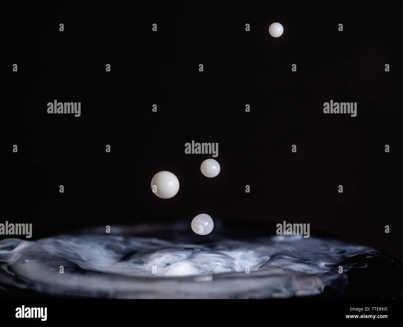 Splash of milk droplets in close up macro high resolution isolated ...