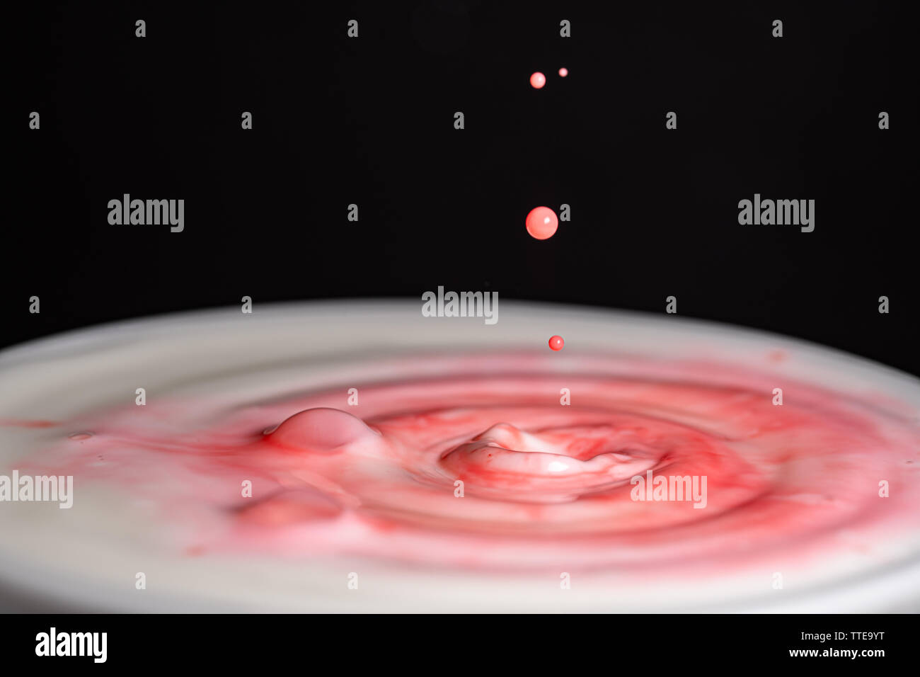 Splash of milk droplets in close up macro high resolution isolated ...