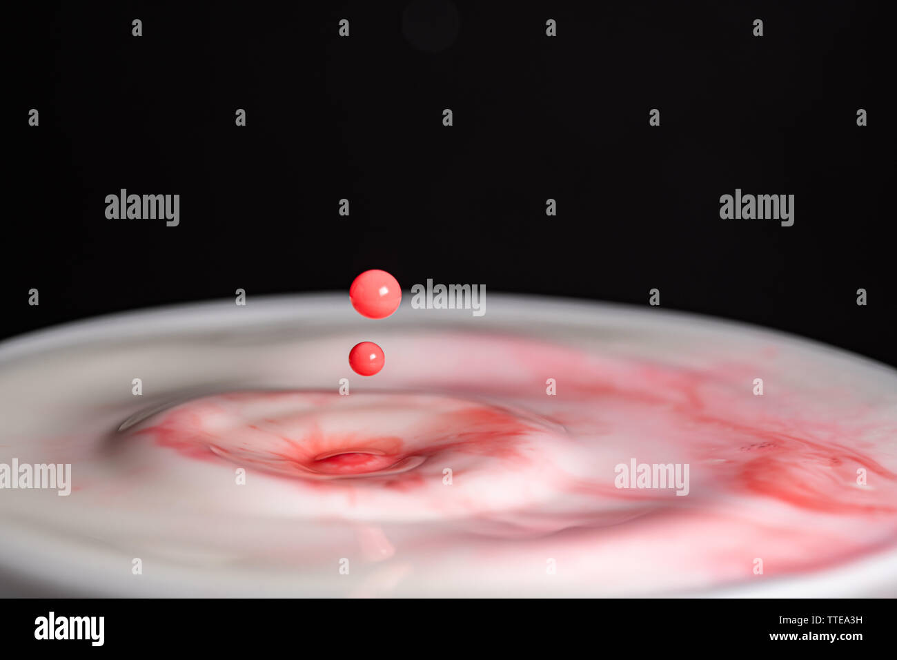 Splash of milk droplets in close up macro high resolution isolated ...