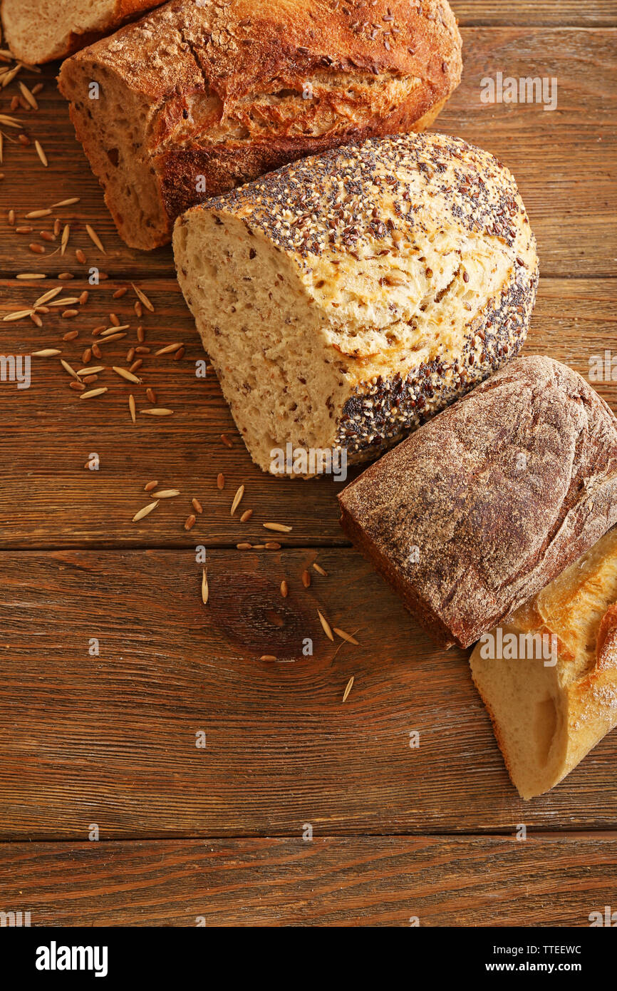 Cut fresh baked bread on the wooden background Stock Photo - Alamy
