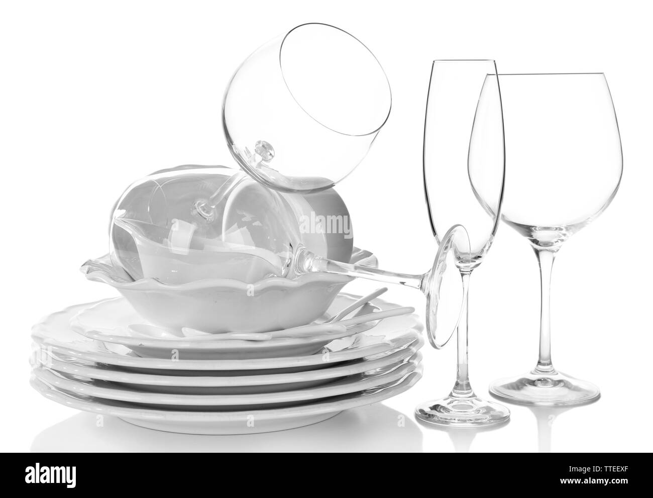 Stack of plates, cups and wineglasses on white background Stock Photo