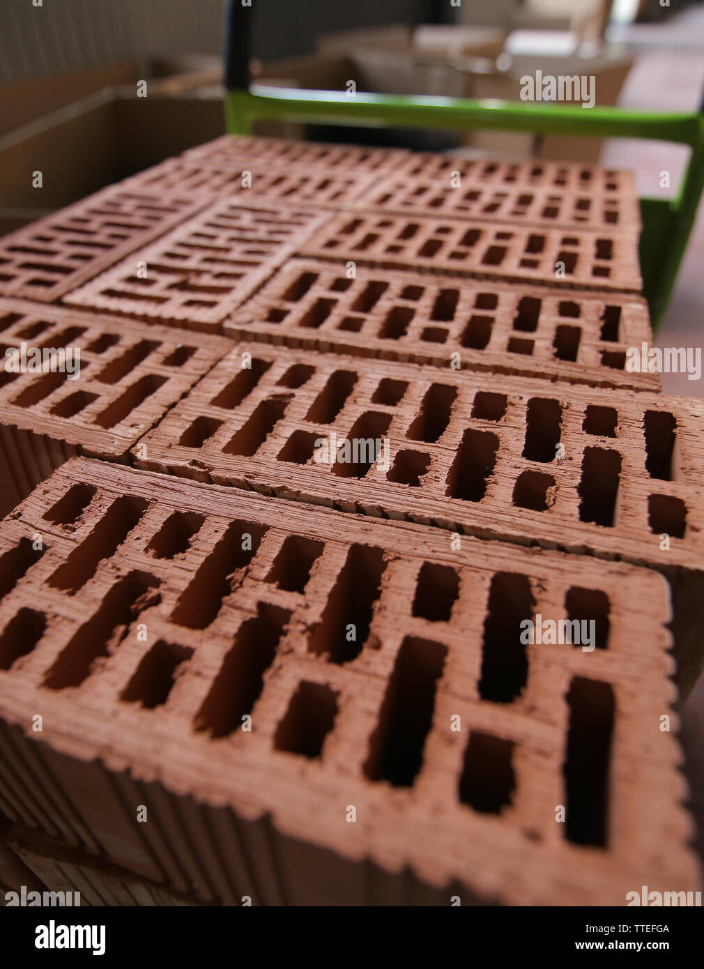 Details of a pile of stacked clay bricks with holes. Stock Photo