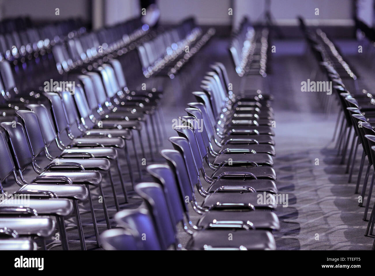 Rows of empty plastic seats in an empty conference room - no people. Stock Photo