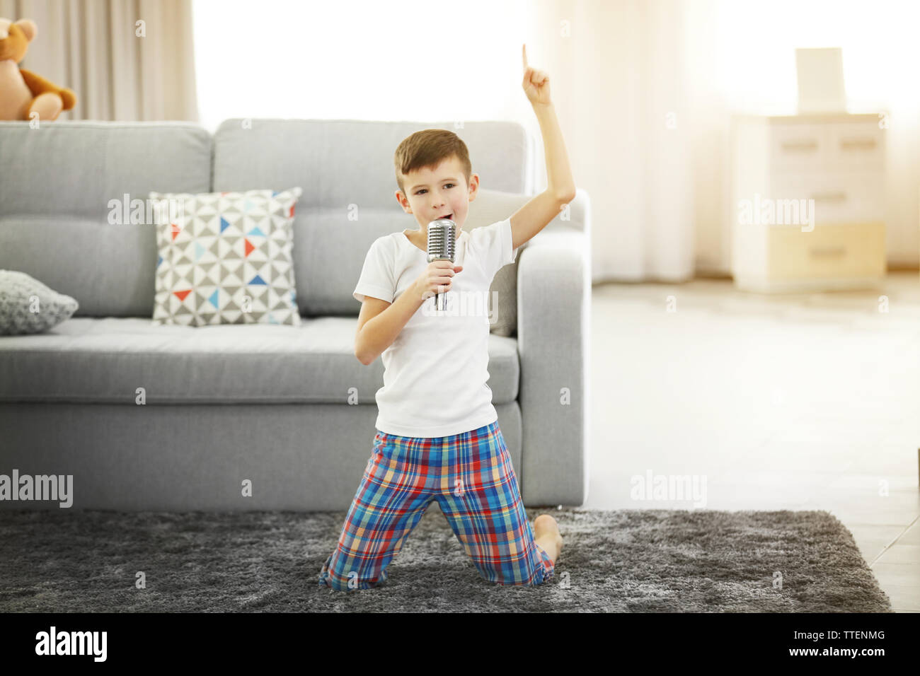 Little boy singing with a microphone at home Stock Photo Alamy