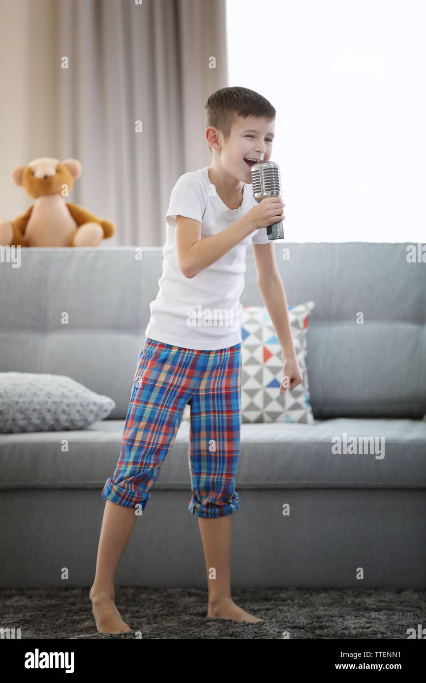 Little boy singing with a microphone at home Stock Photo Alamy