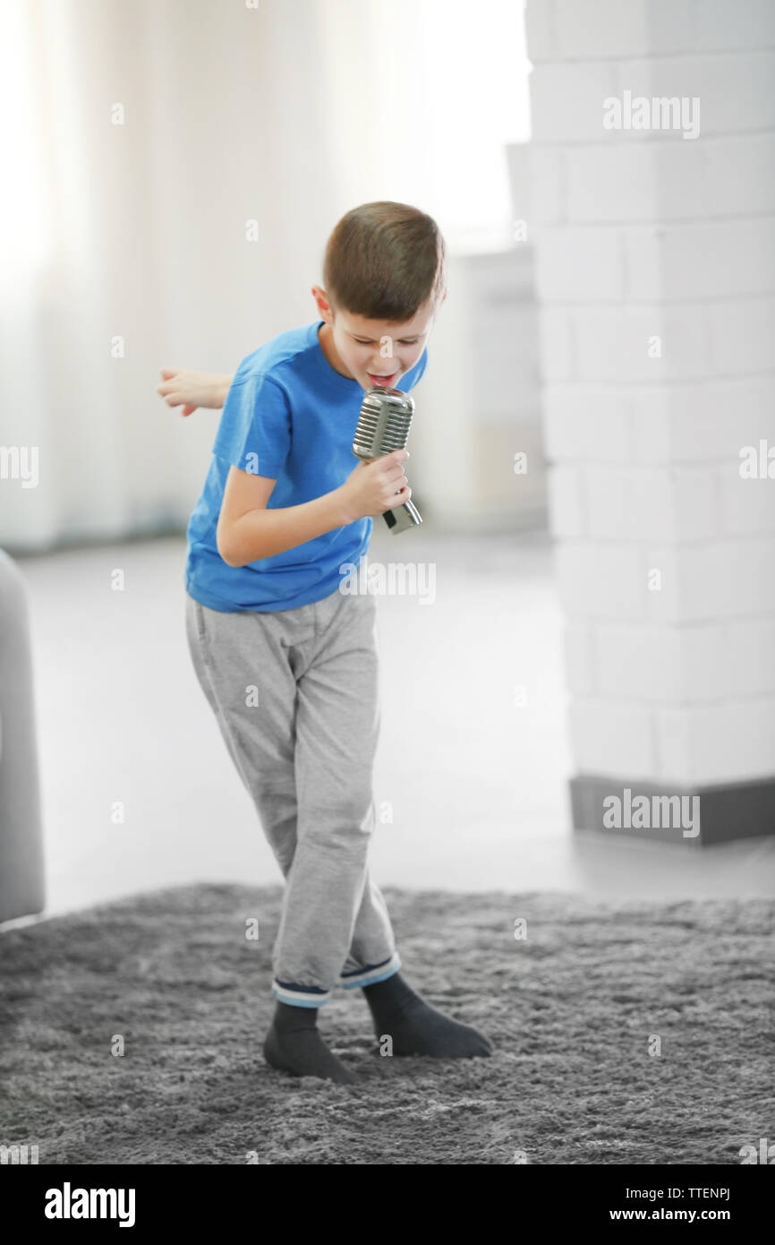 Little boy singing with microphone at home Stock Photo Alamy