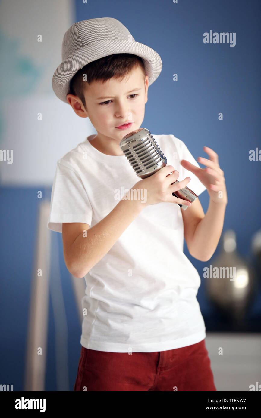 Little boy singing with microphone at home Stock Photo Alamy