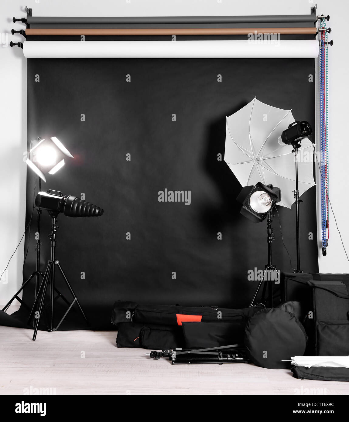 Empty photo studio with lighting equipment, bags and backdrop Stock ...