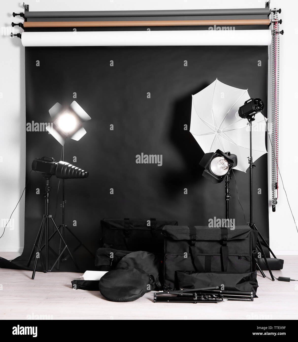 Empty photo studio with lighting equipment, bags and backdrop Stock ...