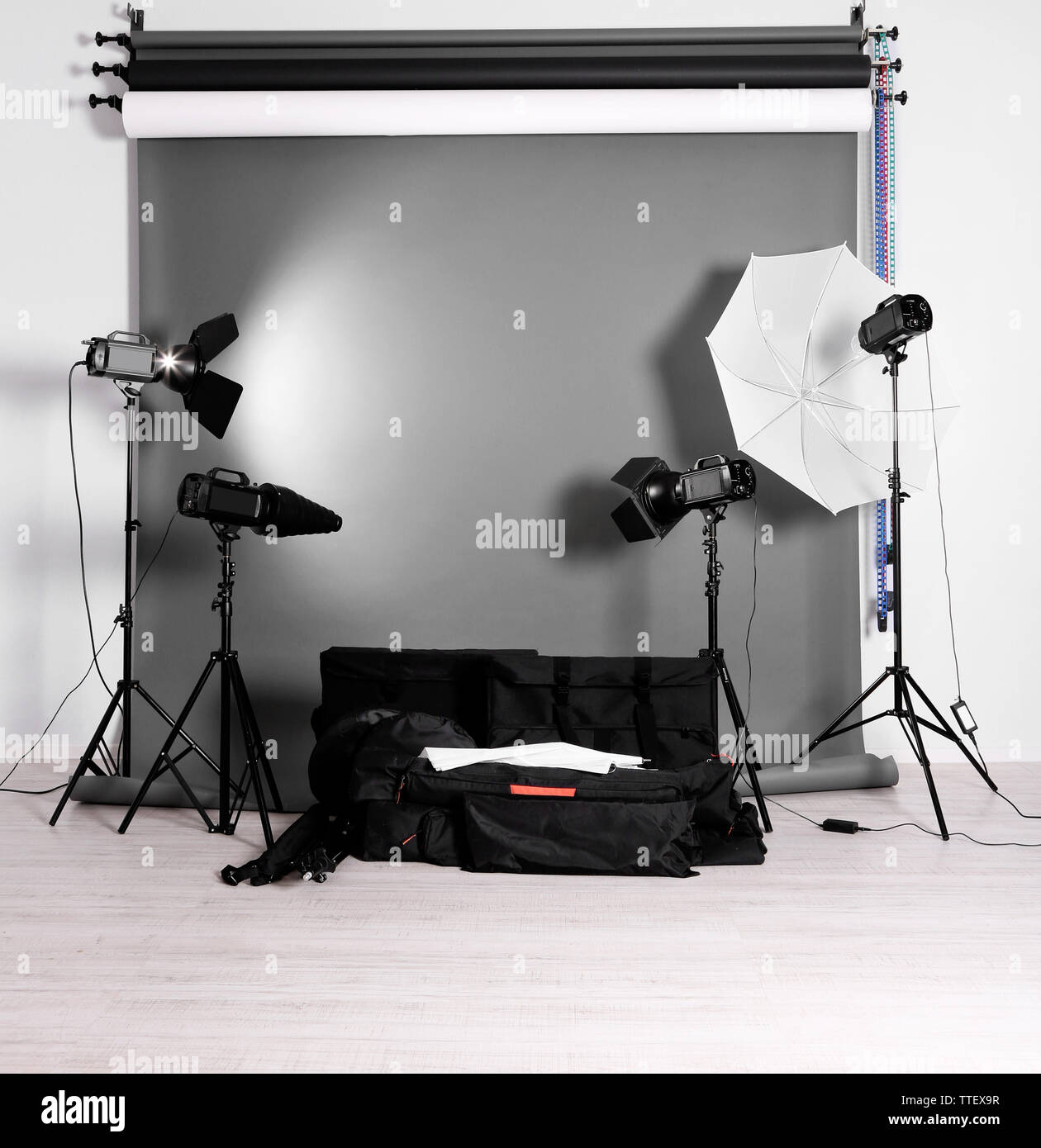 Empty photo studio with lighting equipment, bags and backdrop Stock ...