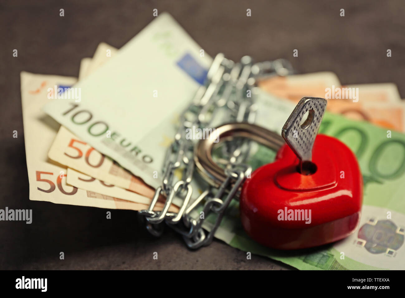 Dollars currency with lock and chain on gray background Stock Photo - Alamy