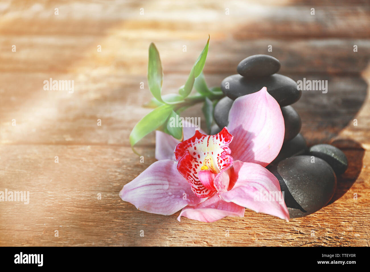 Spa stones with bamboo and pink orchid on wooden background Stock Photo ...
