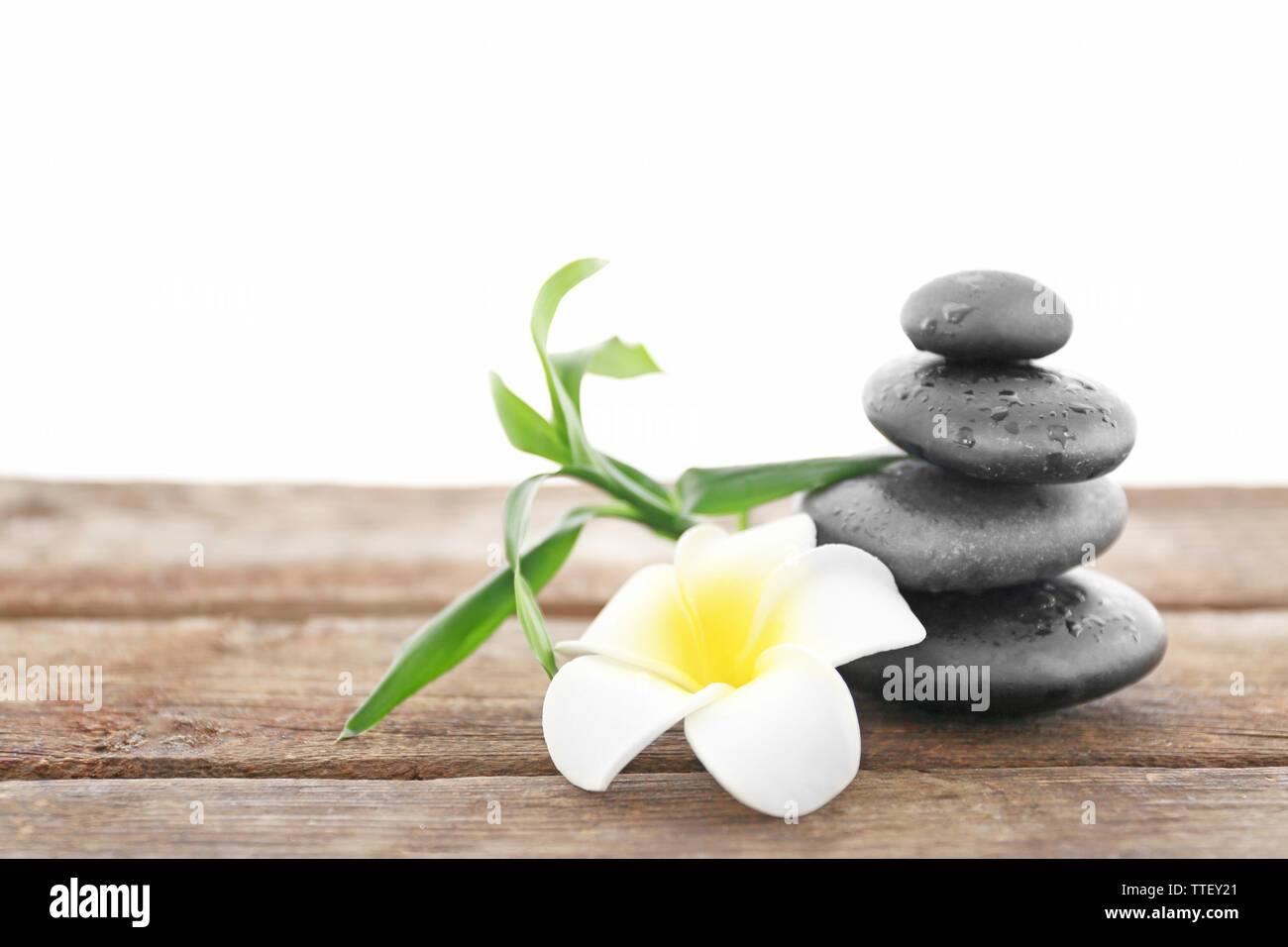 Spa stones with bamboo and tropical flower on white background Stock ...