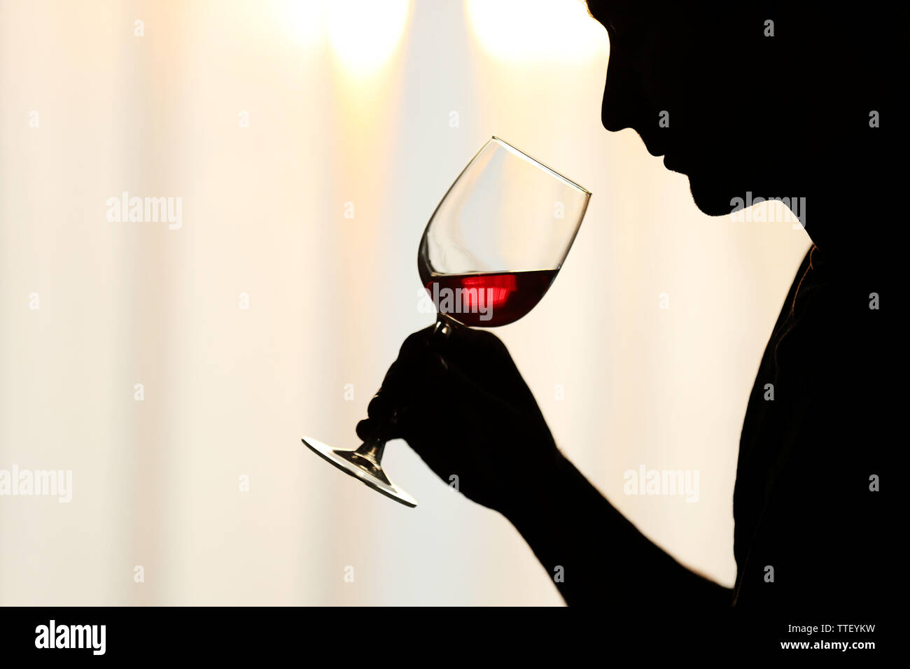 Silhouette of man sniffing red wine in a glass, close up Stock Photo ...