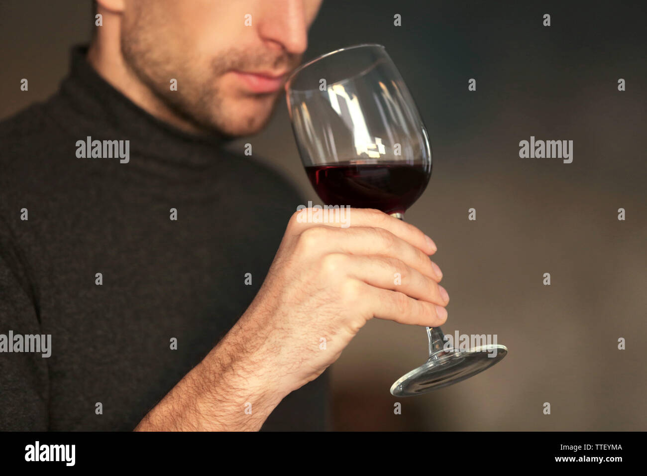 Man sniffing red wine in a glass, close up Stock Photo - Alamy