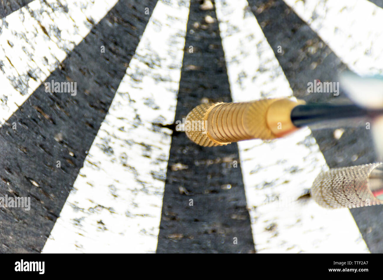 Darts on a Worn Out Dartboard. Proper Targeting Concept. Stock Photo