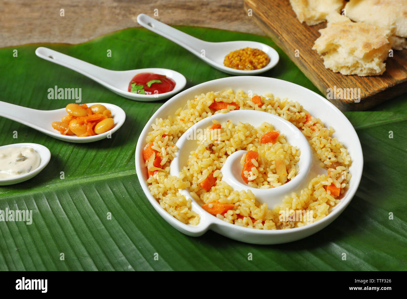 Fried rice with flat bread and spices on banana leaf background Stock ...