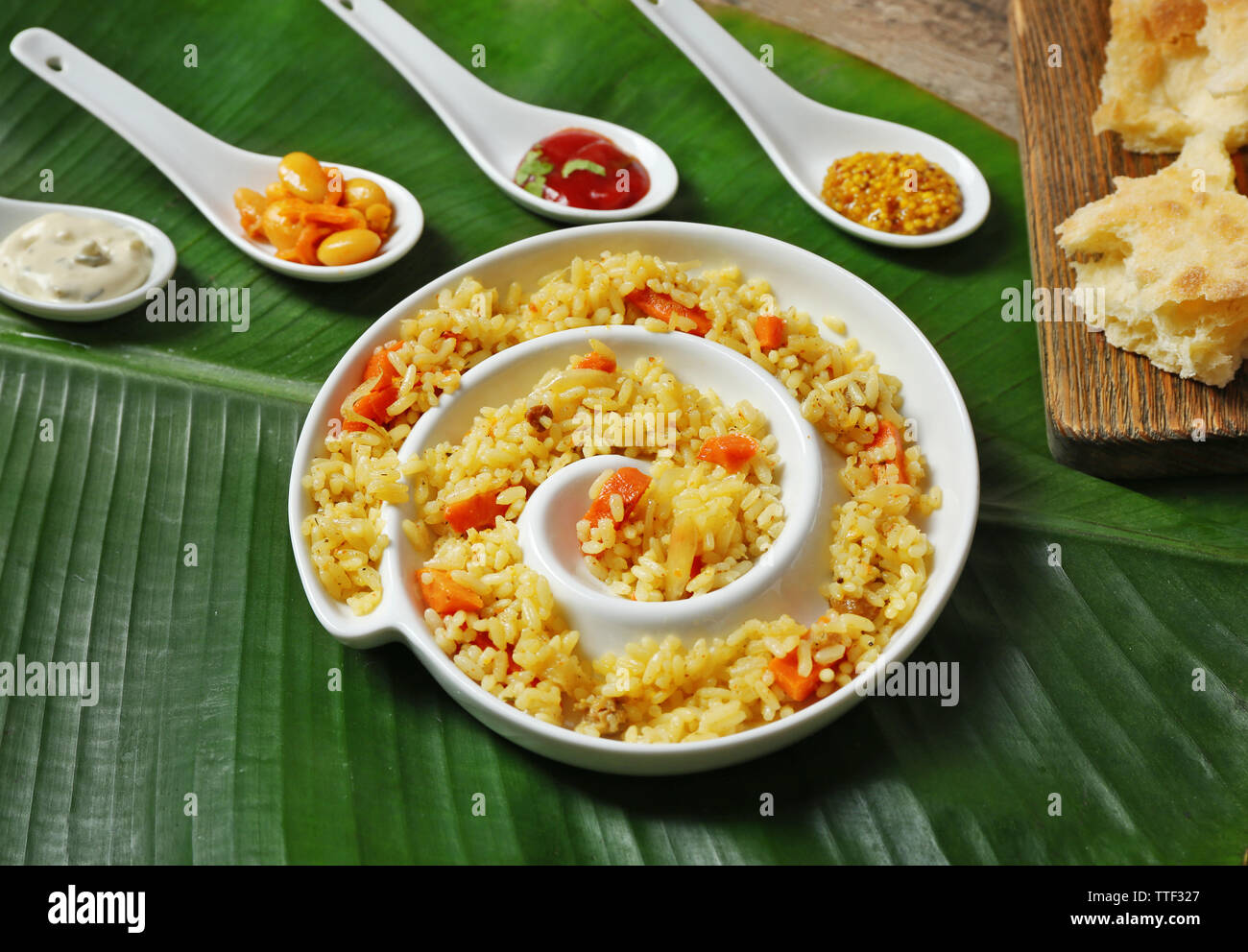 Fried rice with flat bread and spices on banana leaf background Stock ...