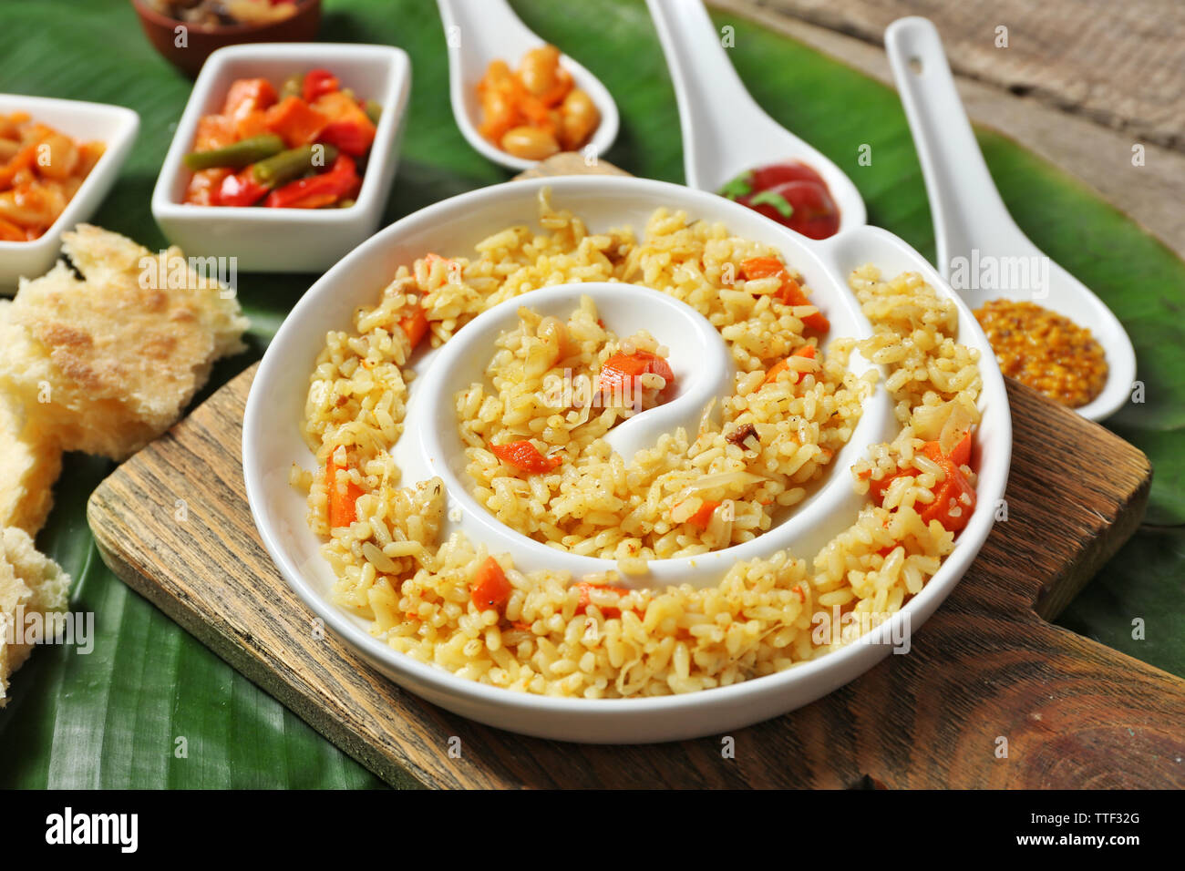 Fried rice with vegetables and flat bread on banana leaf background ...