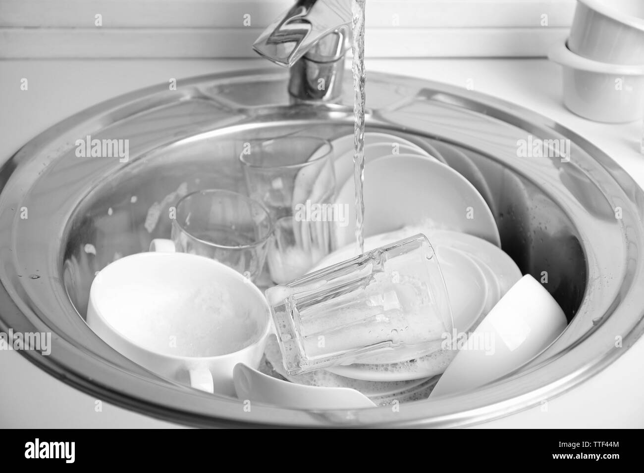 Pile of dishes in sink closeup Stock Photo